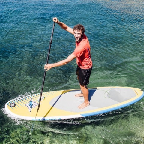 a person riding a wave on a surf board on a body of water