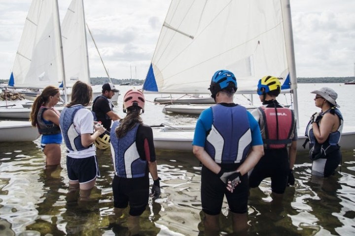 a group of people standing on a boat in the water