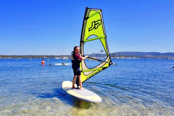 a man riding a surf board on a body of water