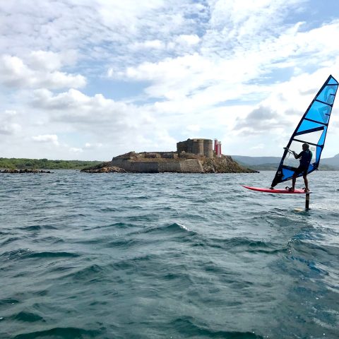 a person riding a surf board on a body of water