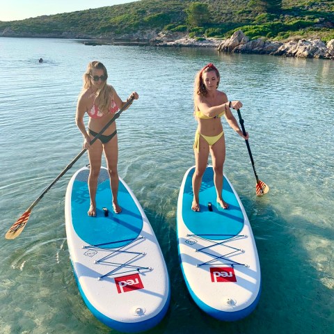 a couple of people that are standing in a body of water