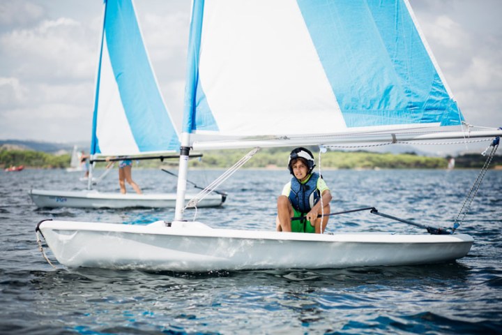 a person riding on the back of a boat in the water