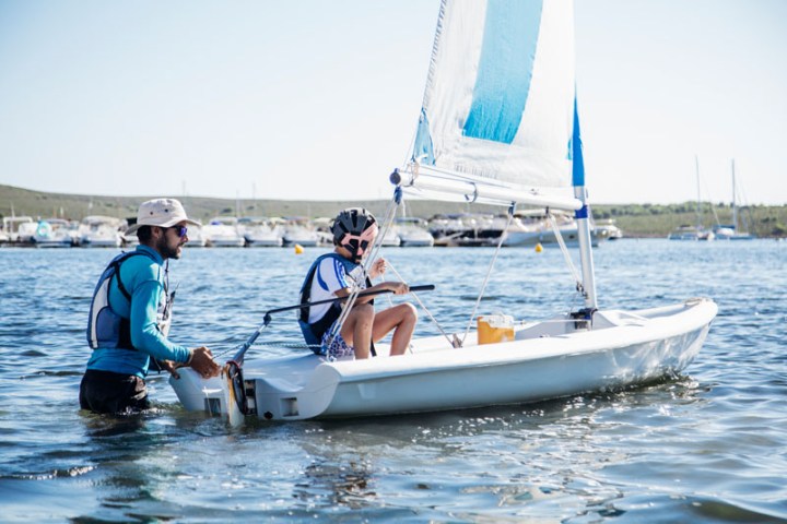 a person riding on the back of a boat in the water