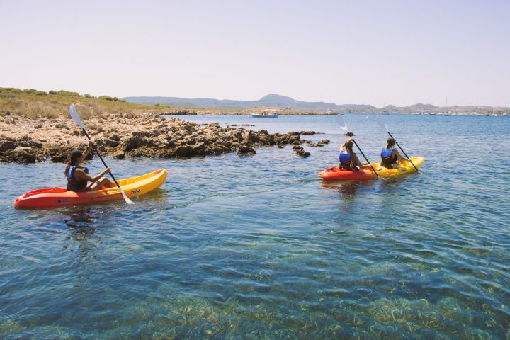 a group of people in a small boat in a body of water