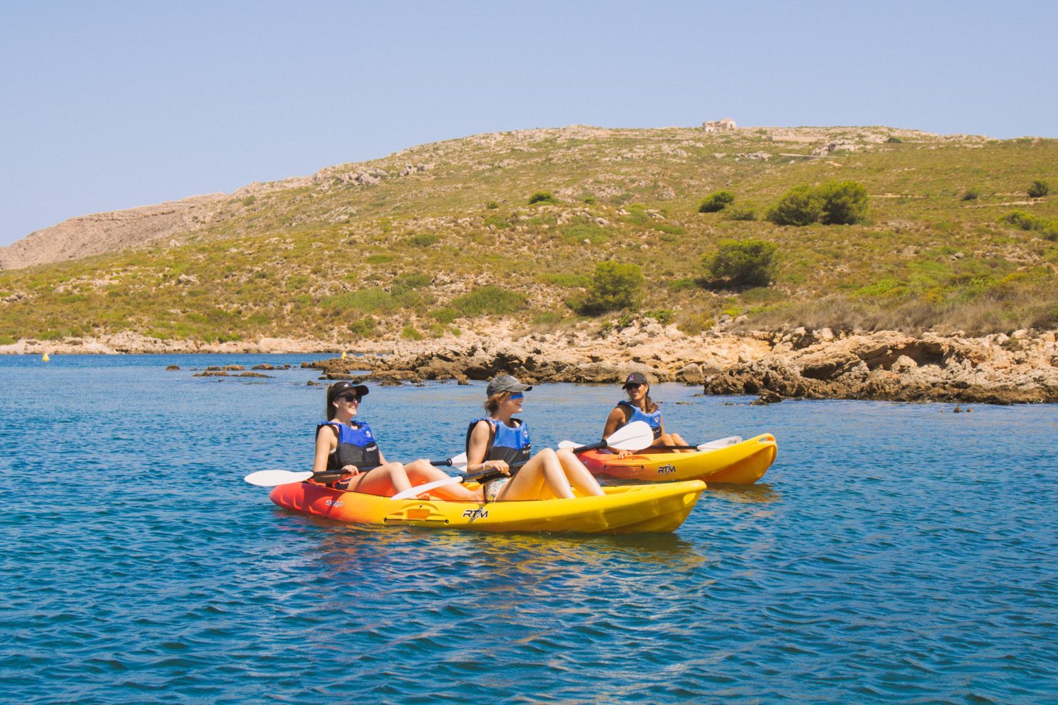 a group of people in a small boat in a body of water