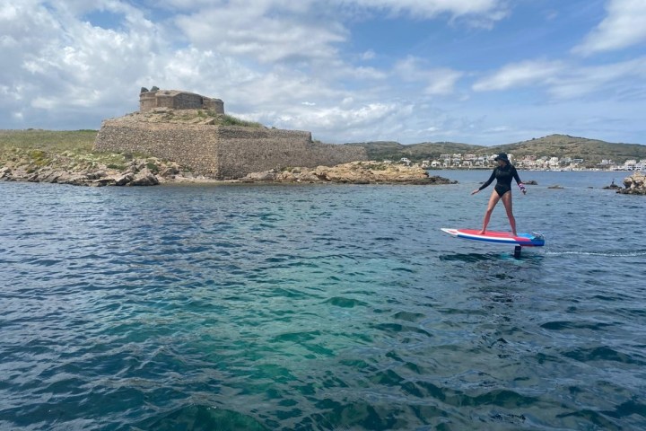 a person riding a surf board on a body of water
