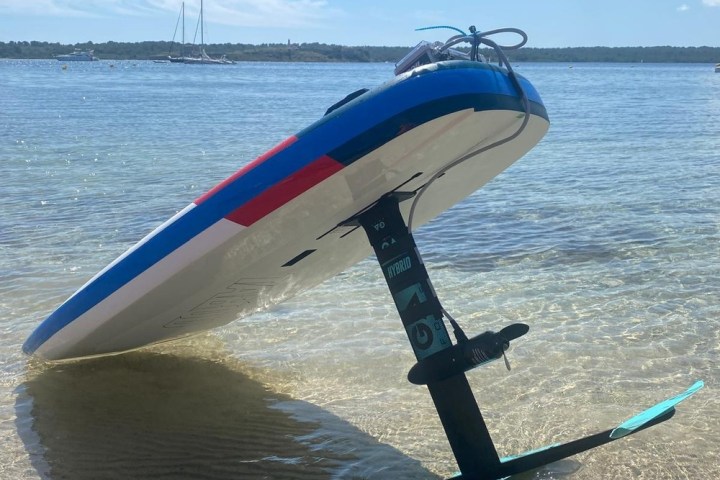 a close up of a sandy beach next to a body of water